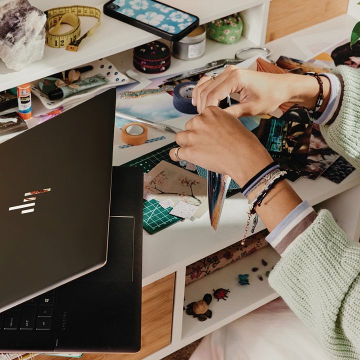 The new HP Spectre x360 16 in use on a desk.