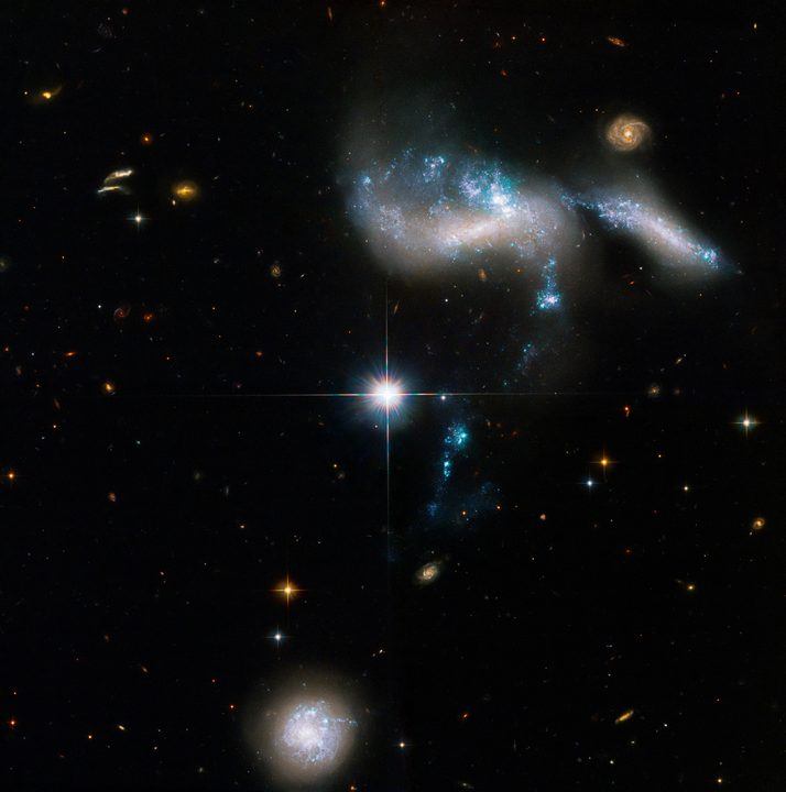 This newly revised NASA Hubble Space Telescope image of the Hickson Compact Group 31 (HCG 31) of galaxies highlights streams of star-formation as four dwarf galaxies interact.