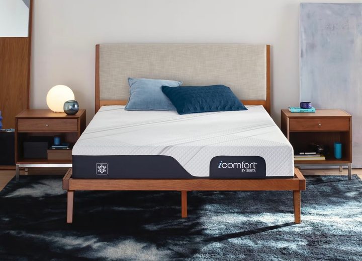 A Serta iComfort Mattress on a wooden bed frame.