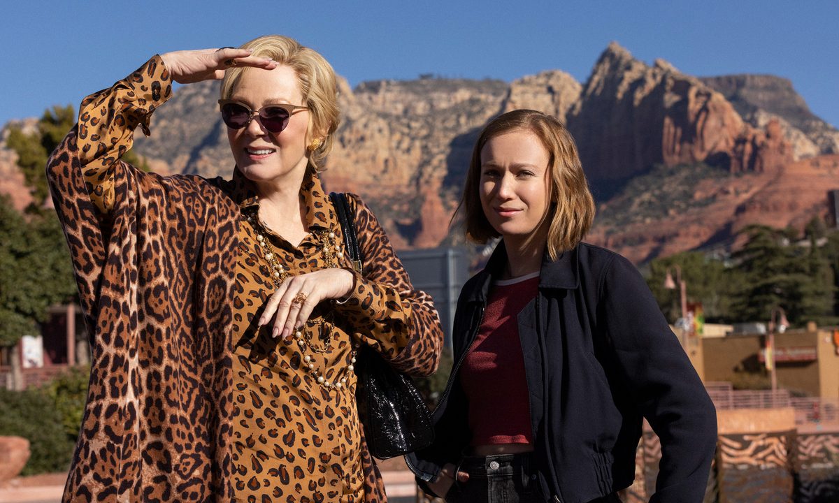 Jean Smart wears a cheetah print shirt while standing next to Hannah Einbinder in Hacks Season 2.