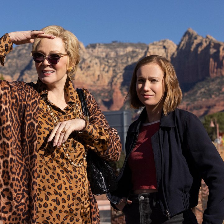 Jean Smart wears a cheetah print shirt while standing next to Hannah Einbinder in Hacks Season 2.