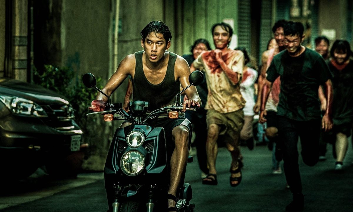 Jim drives away on his motorcycle from a group of crazed zombies in The Sadness.