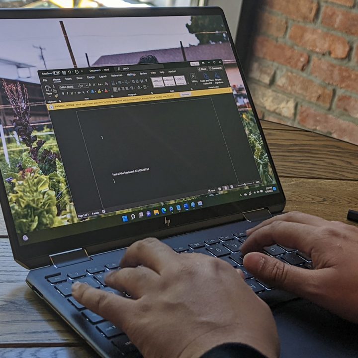A man typing on the Spectre x360 13.5 inch.