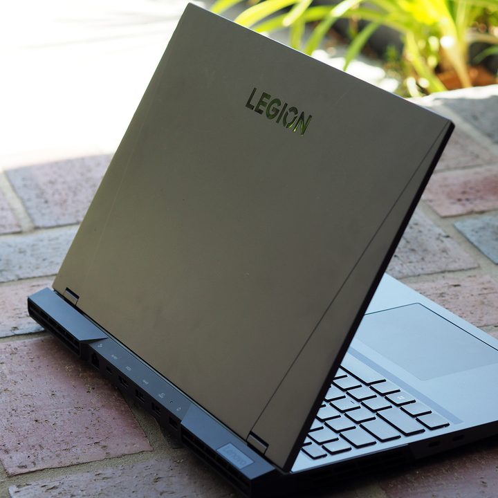 Lenovo Legion laptop on a brick surface.