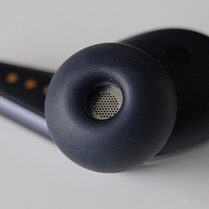 Close-up of wireless earbuds speaker grill.