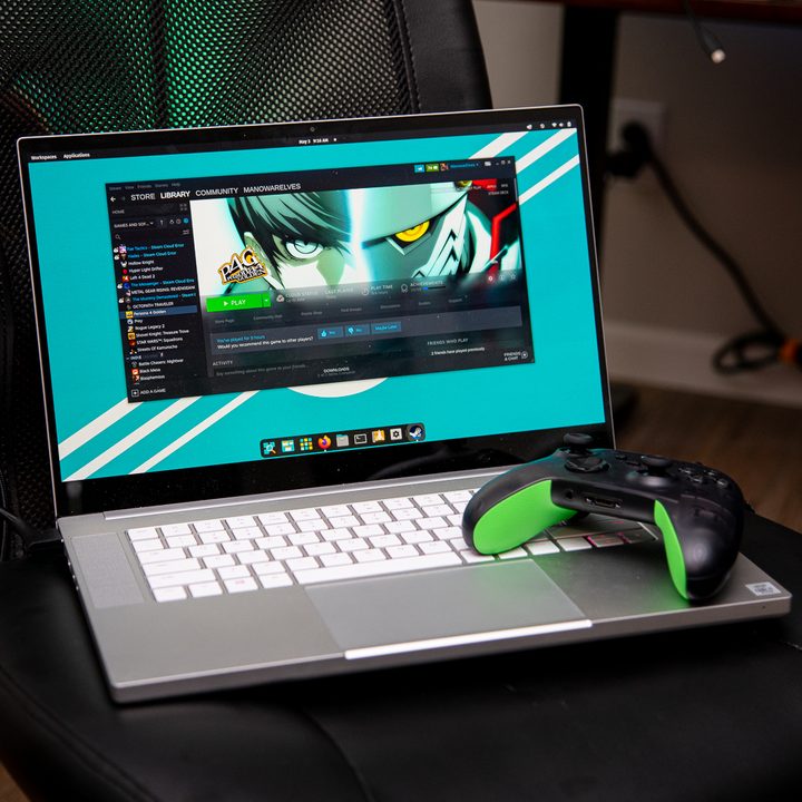 A laptop running Linux with a controller sitting on it.