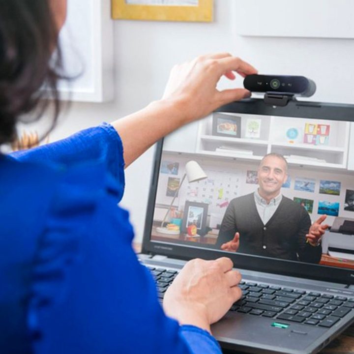 A woman uses the Logitech 4K Pro Webcam for a video call.