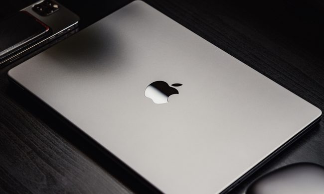 MacBook Pro in space grey sitting on a desk.