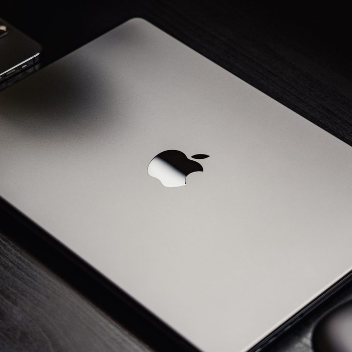 MacBook Pro in space grey sitting on a desk.