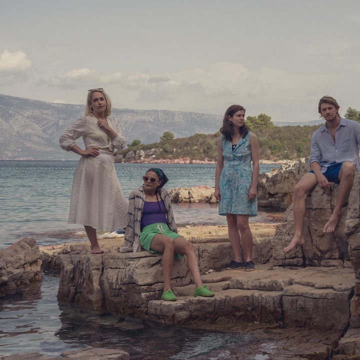Melissa, Bobbi, Frances, and Nick all sit and stand near the sea in Conversations with Friends.