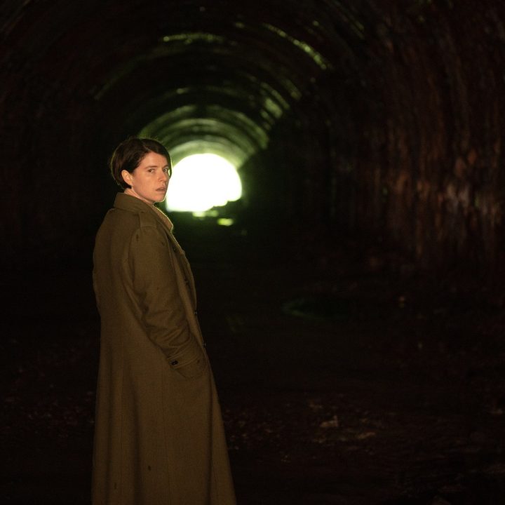 Jessie Buckley prepares to walk down a dark tunnel in a scene from Men.