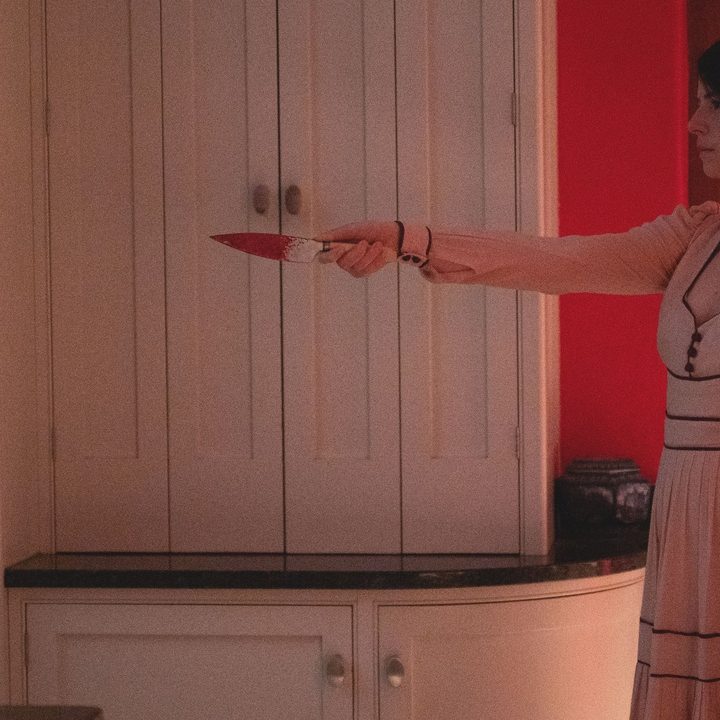 Jessie Buckley holds a knife in a scene from Men.