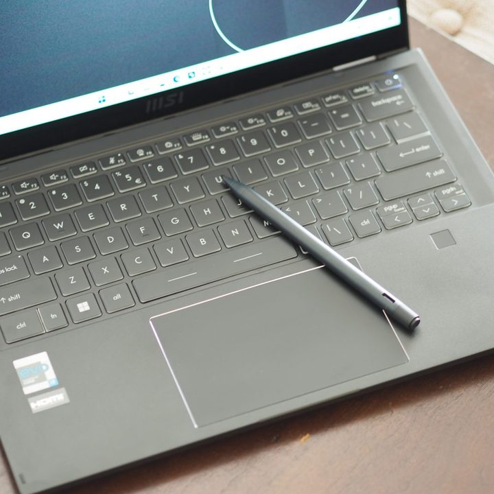 MSI Summit E14 Flip top down view showing keyboard, touchpad, and pen.