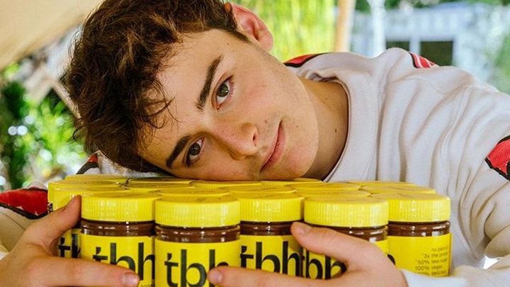 Noah Schnapp rests his head on some jars.