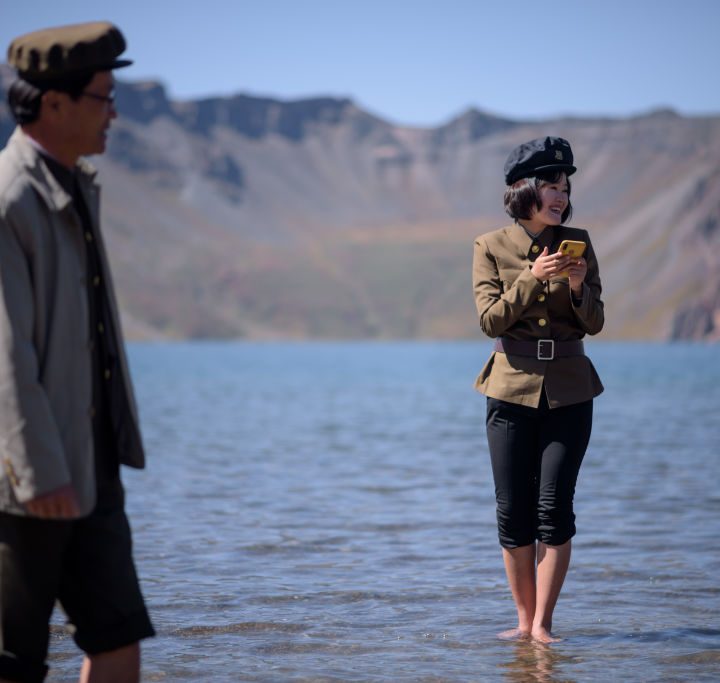 North Korean student holds a mobile phone.