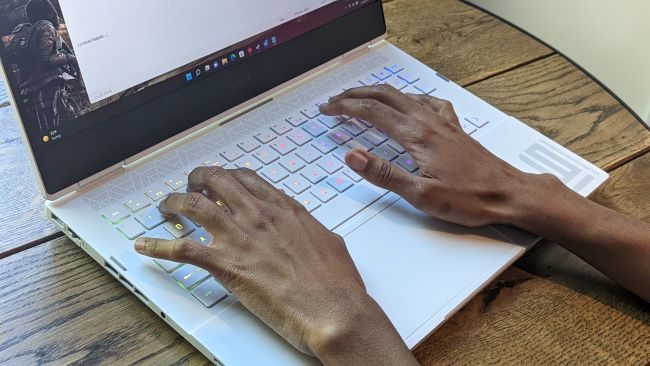 Hands on the keyboard of the HP Omen 16.