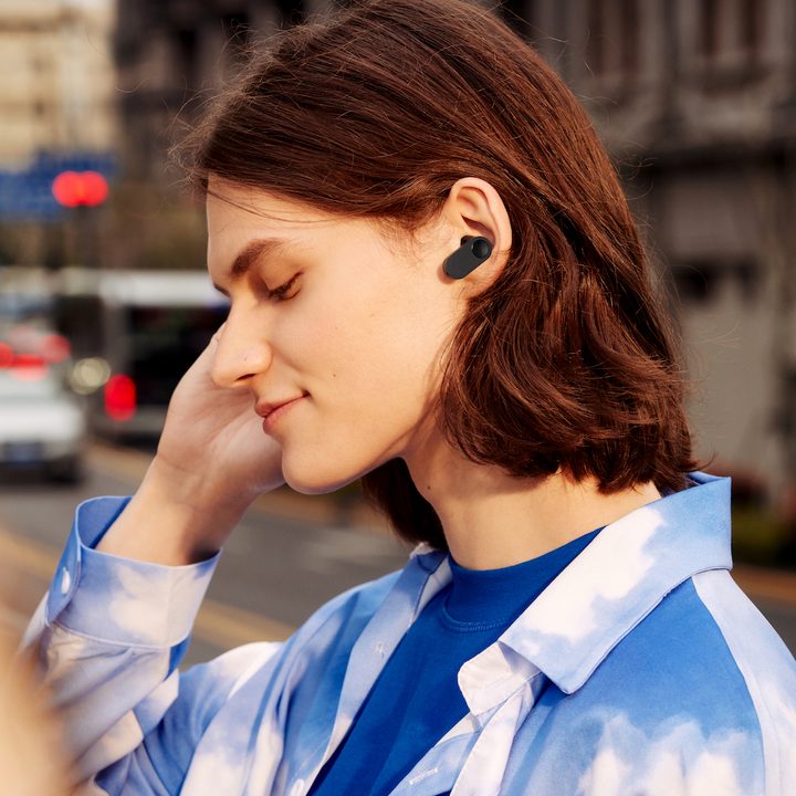 Model wearing the OnePlus Nord Buds in their ear.