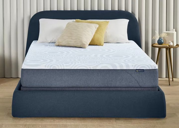 A Serta Perfect Sleeper Mattress on a plush bed frame.