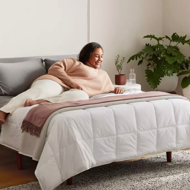 A woman lies on top of a Purple Mattress.