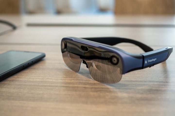 Qualcomm Snapdragon reference XR smart glasses on a table next to a smartphone.