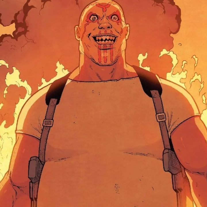 A deranged Raoul Bushman wearing face paint and standing in front of a fire in the comics.