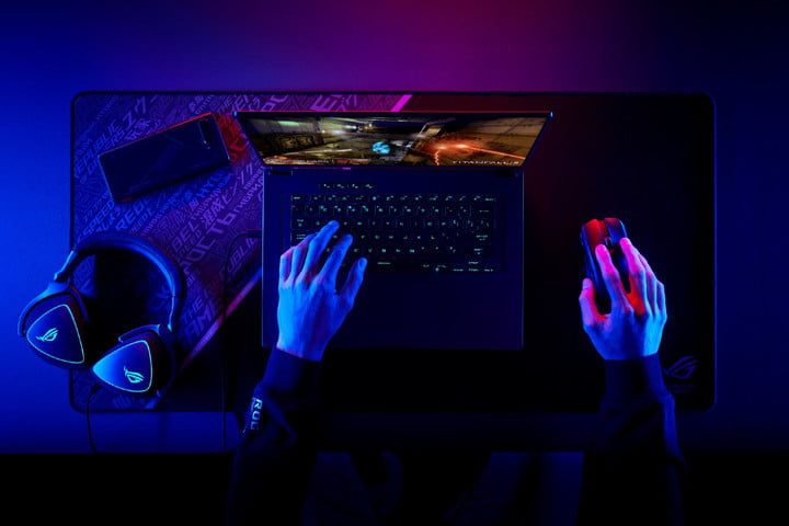 Someone playing the ROG Flow Z16 with accessories nearby.