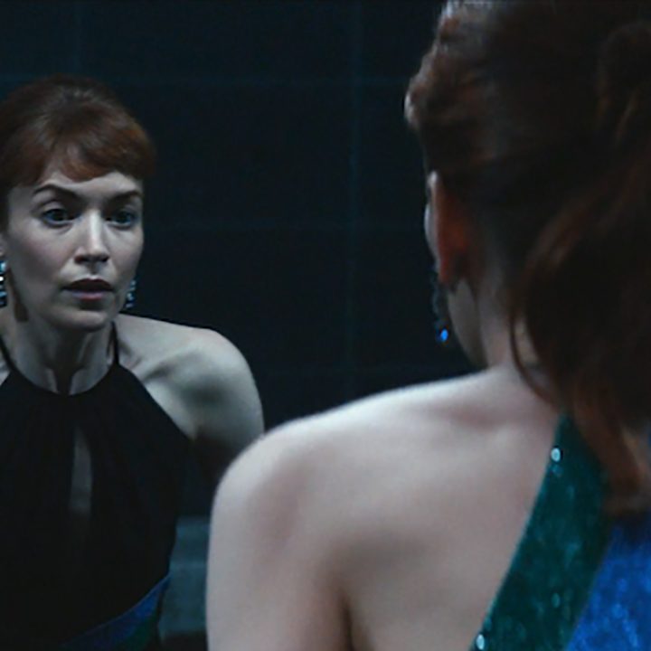 Helly looking in the mirror at her outie self in a scene from the finale of Severance on Apple TV+.