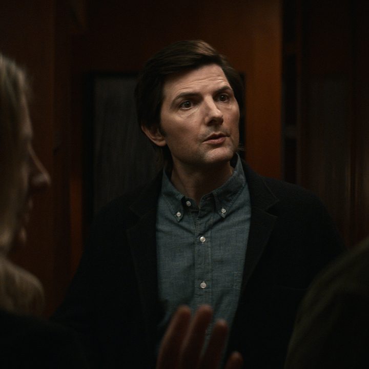 Mark talking to people at a party in a scene from Apple TV+'s Severance.