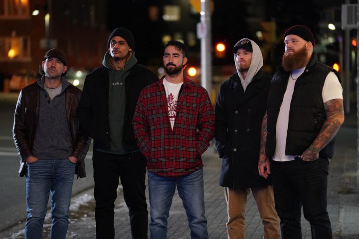 The cast of Shoresy stands on the street.