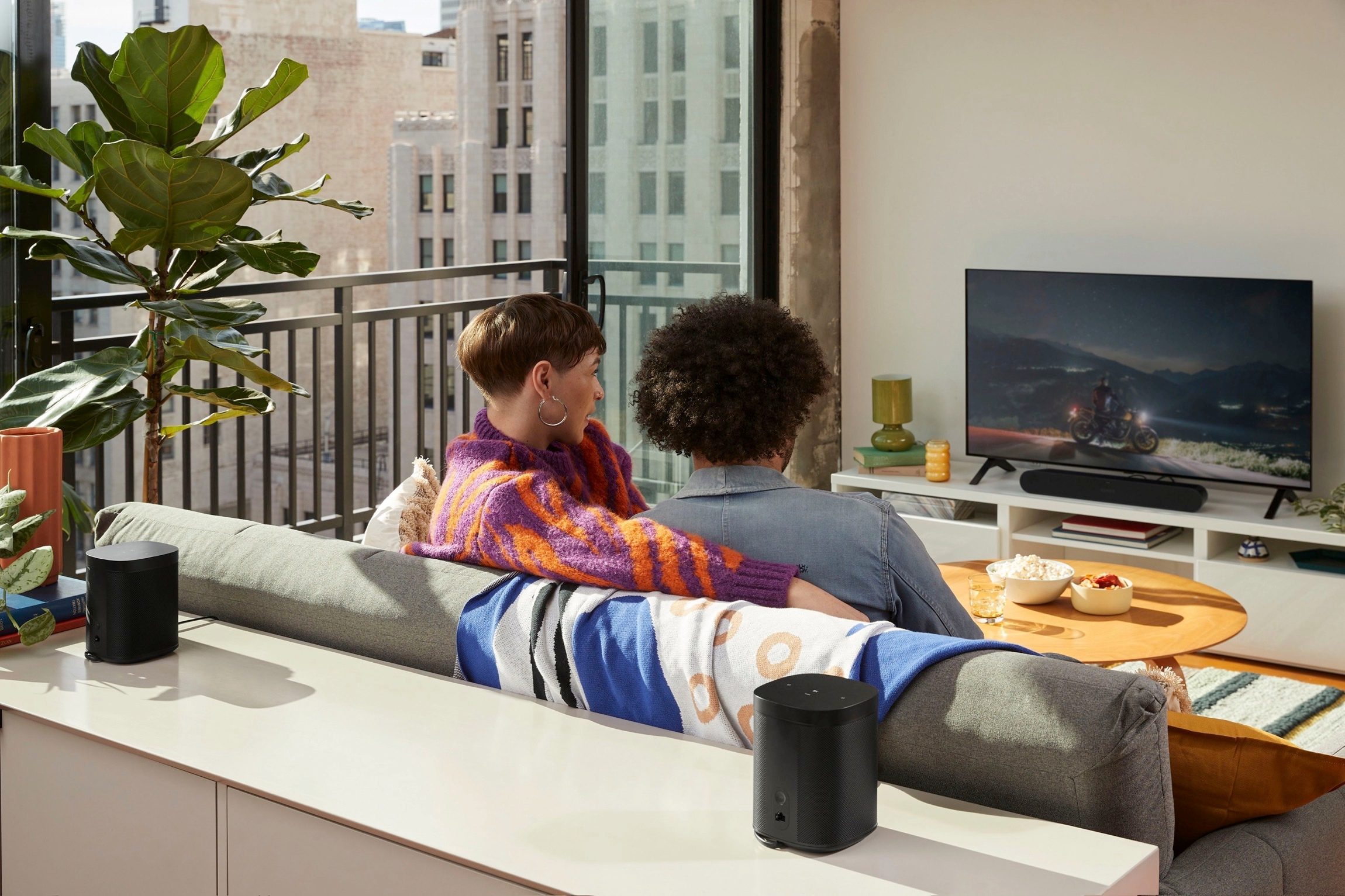 Leaked publicity photo of a new Sonos soundbar seen in a home theater arrangement with Sonos One or One SL speakers as the surro