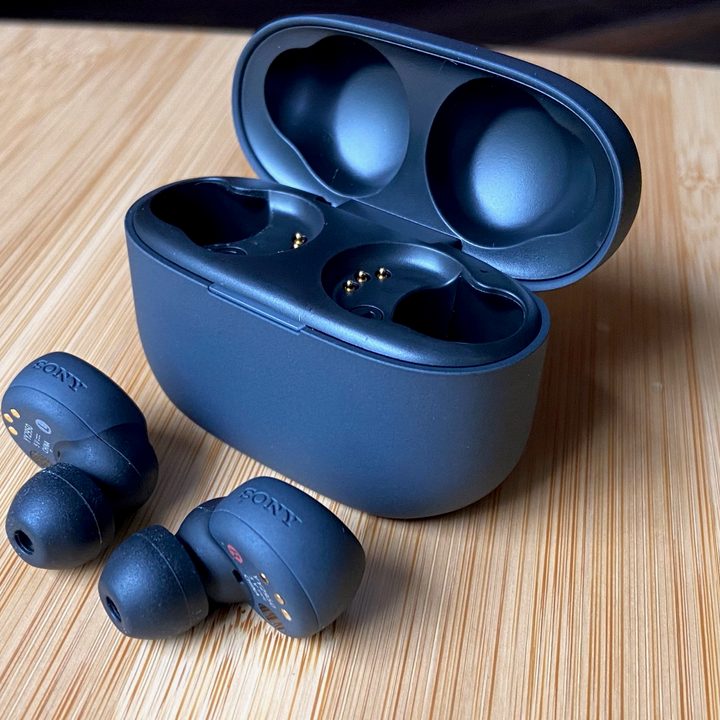 Sony LinkBuds S in front of their case.