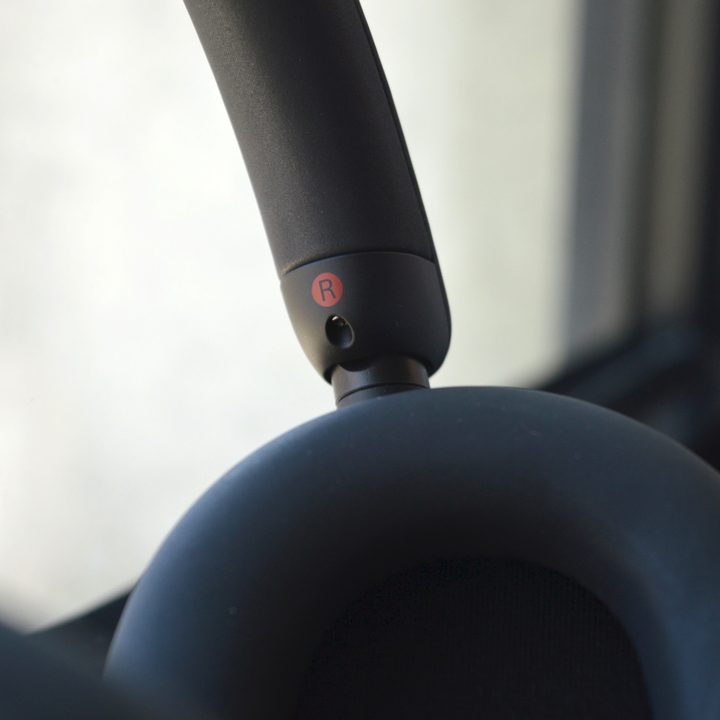 Close-up of earcup-pivot on Sony WH-1000XM5 wireless headphones.
