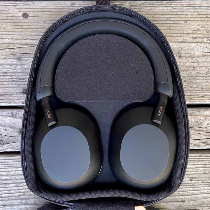 Sony WH-1000XM5 wireless headphones in travel case.