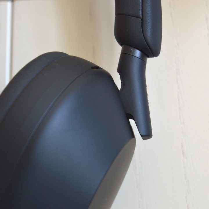 Close-up of earcup-pivot on Sony WH-1000XM5 wireless headphones.