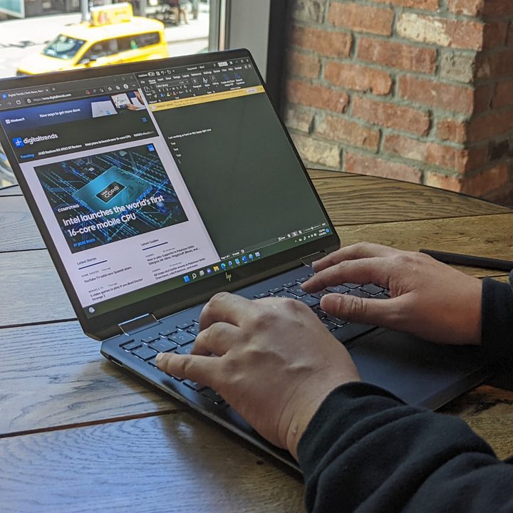 A man using the Spectre x360 13.5 inch looking at the display.