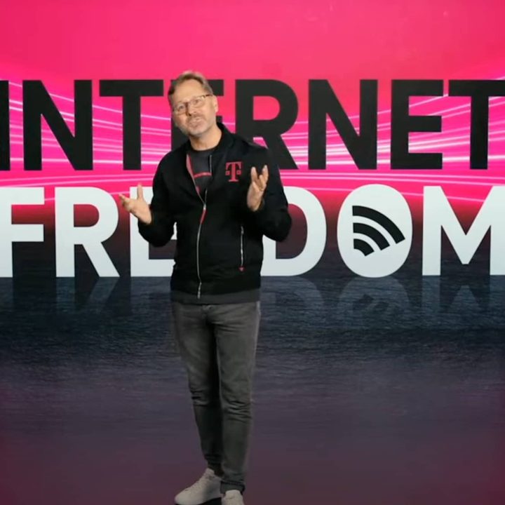 T-Mobile CEO Mike Sievert standing in front of a banner that reads Internet Freedom.