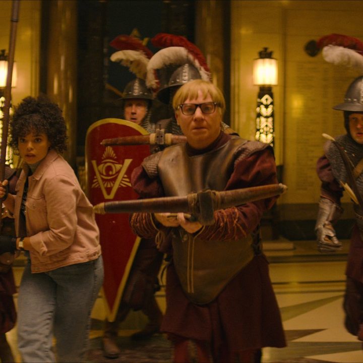 Mike Myers marches toward the camera, holding a crossbow, in a scene from The Pentaverate.