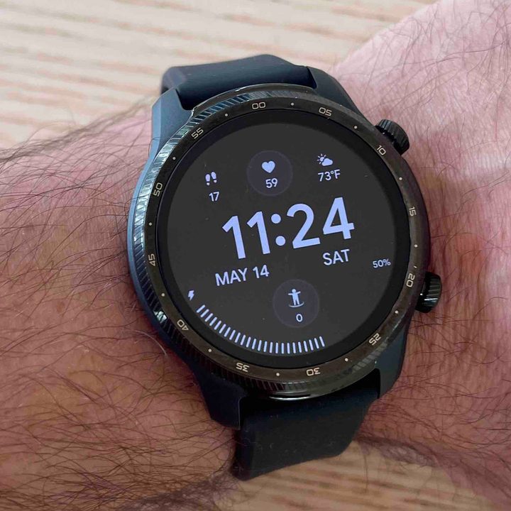 A man wears a A TicWatch Pro 3 Ultra on his left wrist.