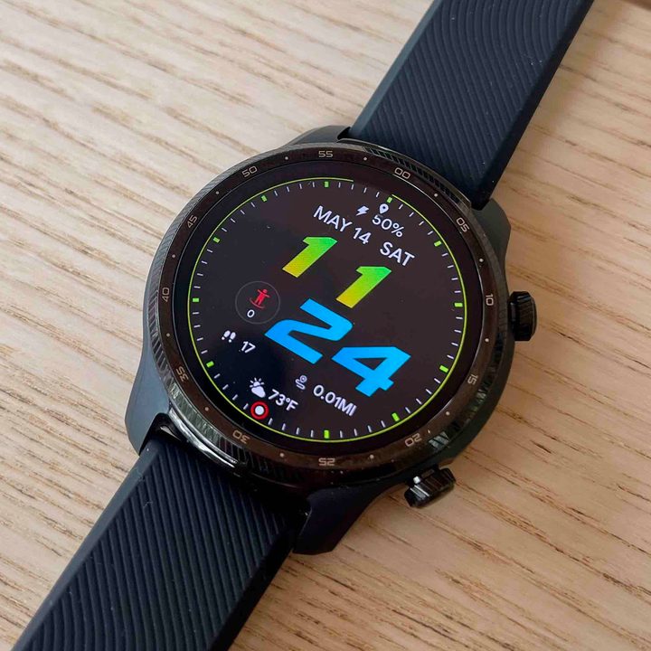 A TicWatch Pro 3 Ultra sits flat on a wooden surface.