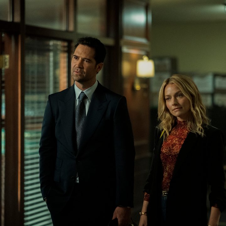 Mickey and Lorna stand in their office in a scene from The Lincoln Lawyer.