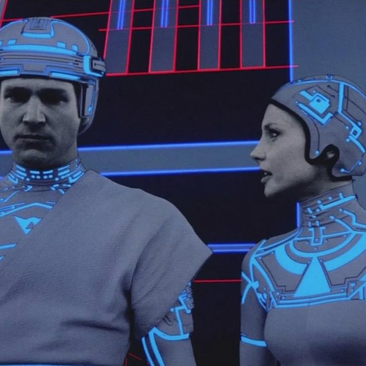 A VR woman looks at a VR man in 1982's Tron.