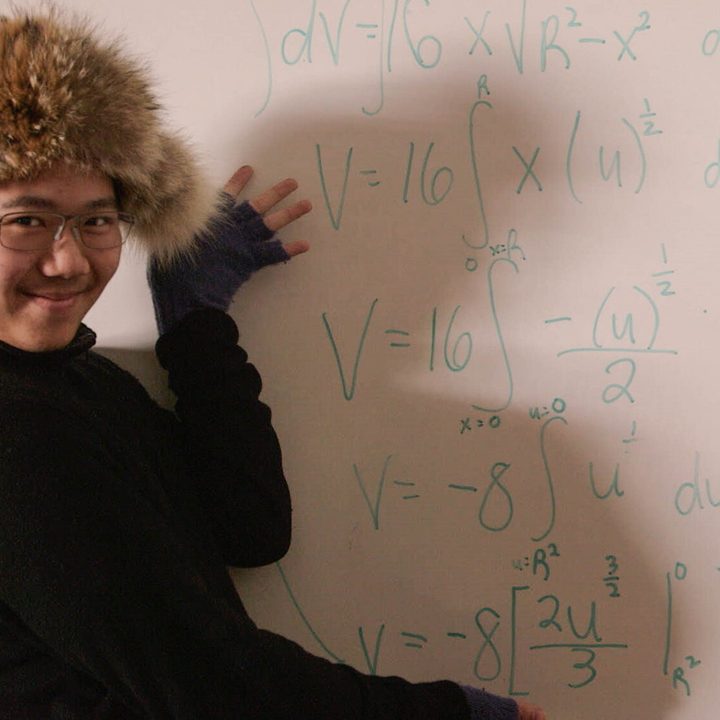 A boy poses in front of a white board in Try Harder!