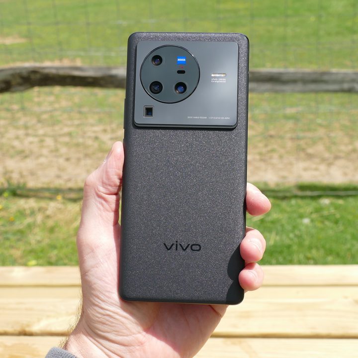 The Vivo X80 Pro held in a man's hand, seen from the back.