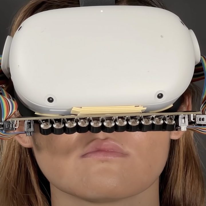 VR headset on woman with mouth sensor.