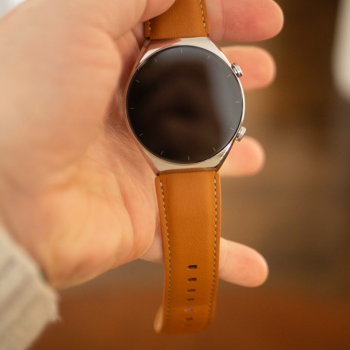 A hand holding the Xiaomi S1 smartwatch