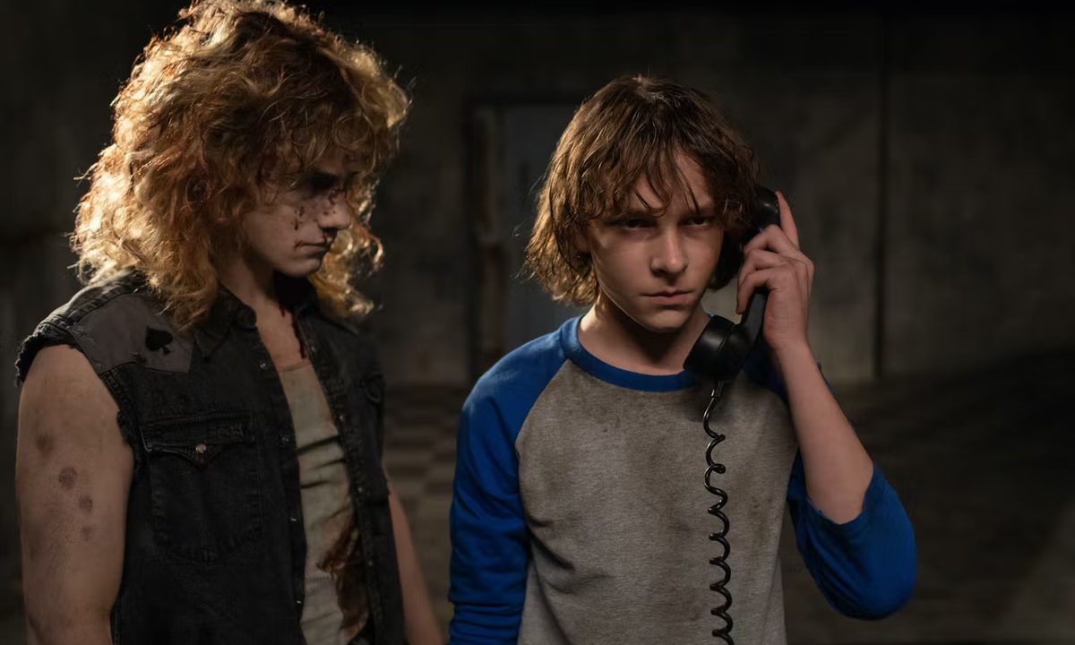 A ghost stands next to Finney in The Black Phone.