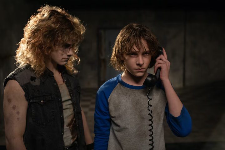 A ghost stands next to Finney in The Black Phone.