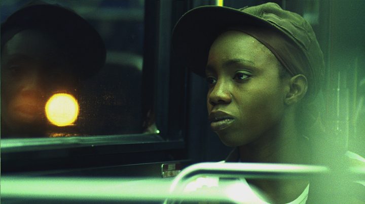 Alike looking out a window while ridiing the bus in Pariah.