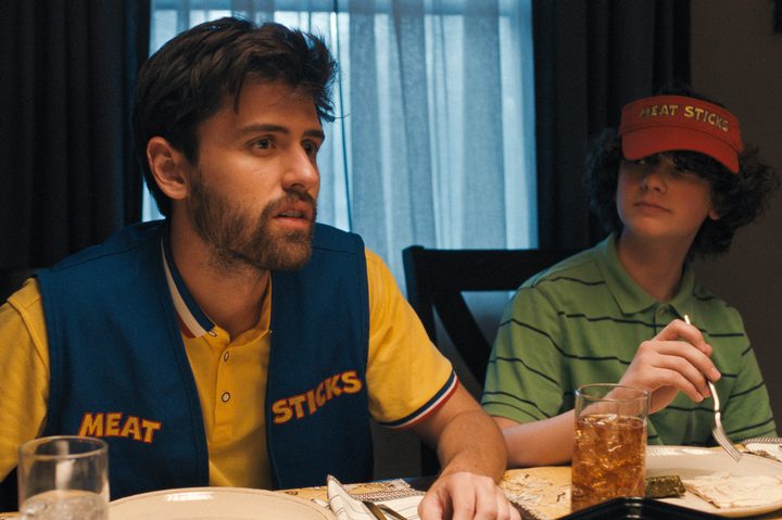 Andrew and David sit at a dinner table together in Cha Cha Real Smooth.