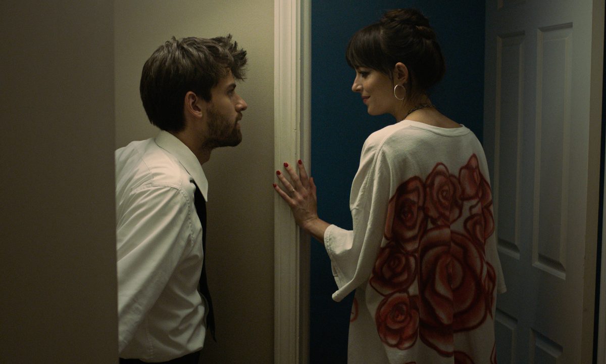 Andrew and Domino look at each other in Cha Cha Real Smooth.